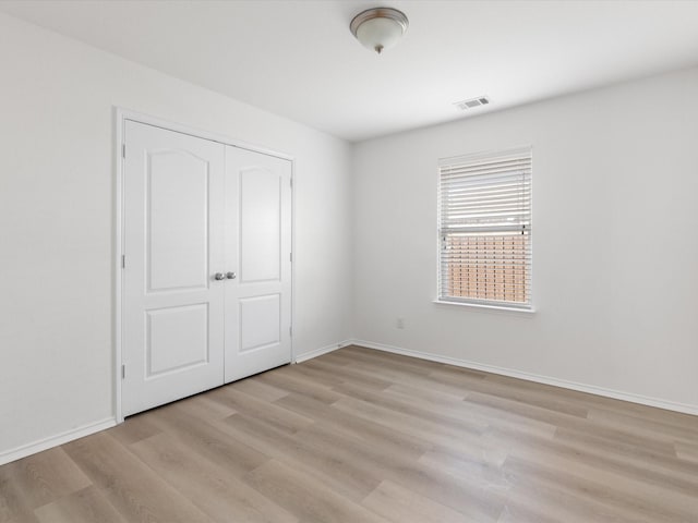 6813 Falconer Way, Fort Worth, TX 76179 - unfurnished bedroom with light wood-style floors, a closet, and baseboards