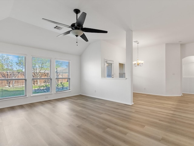 6813 Falconer Way, Fort Worth, TX 76179 - unfurnished living room with lofted ceiling, a chandelier, a ceiling fan, light wood-type flooring, and arched walkways