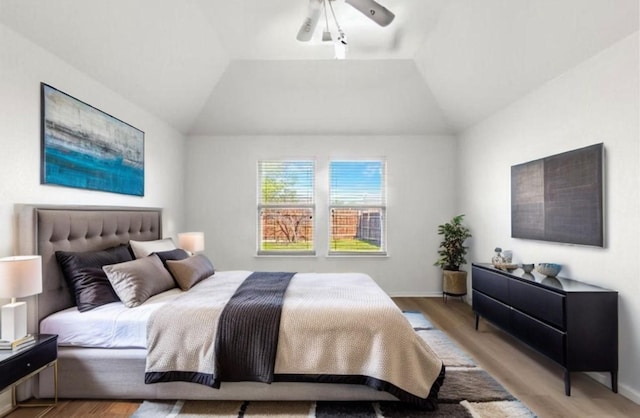 6813 Falconer Way, Fort Worth, TX 76179 - bedroom with wood finished floors, vaulted ceiling, and baseboards