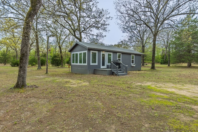 rear view of house featuring metal roof