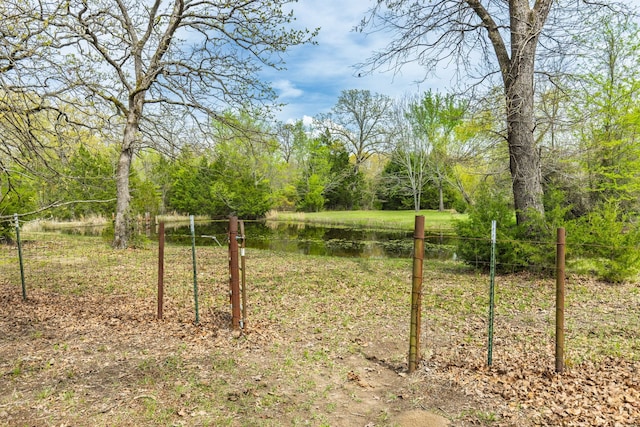 view of yard with fence and a water view