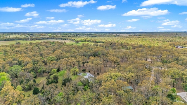 drone / aerial view featuring a wooded view