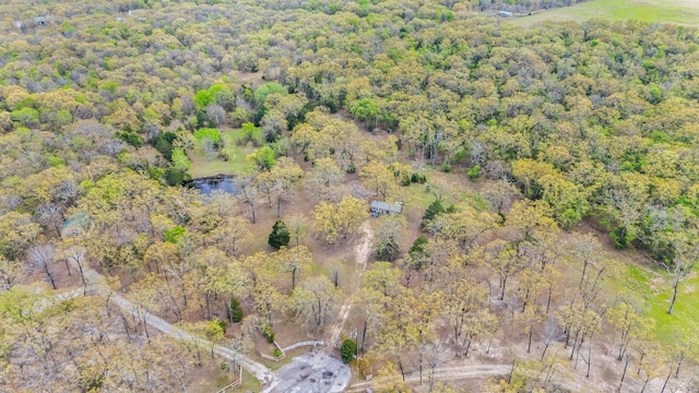 drone / aerial view featuring a forest view