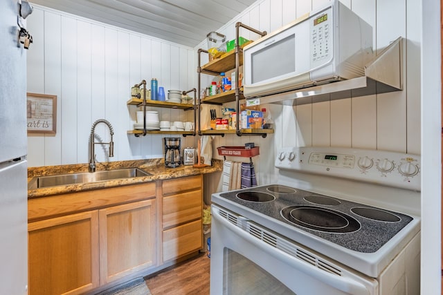 kitchen with light wood-style floors, white appliances, stone counters, open shelves, and a sink