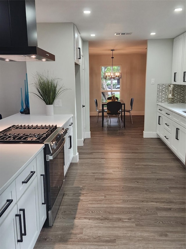 5515 Enchanted Ln, Dallas, TX 75227 - kitchen with stainless steel range with gas stovetop, wall chimney range hood, recessed lighting, baseboards, and a chandelier