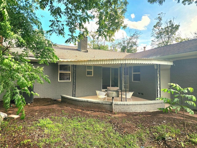 5515 Enchanted Ln, Dallas, TX 75227 - rear view of property with brick siding, a patio, a chimney, and a shingled roof