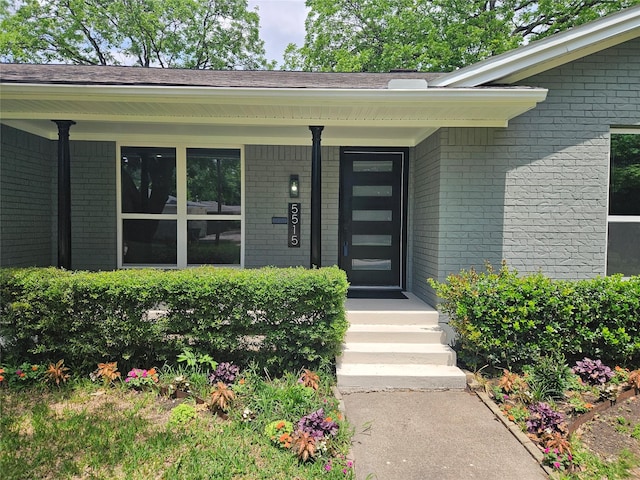 5515 Enchanted Ln, Dallas, TX 75227 - doorway to property featuring brick siding and covered porch