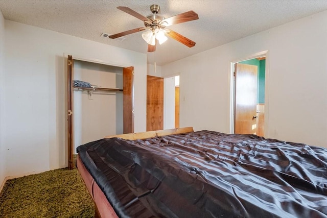 bedroom with carpet, visible vents, a closet, and a textured ceiling