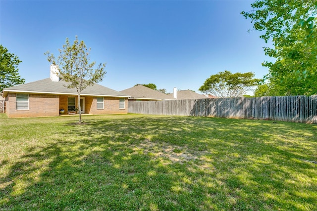 view of yard featuring a fenced backyard