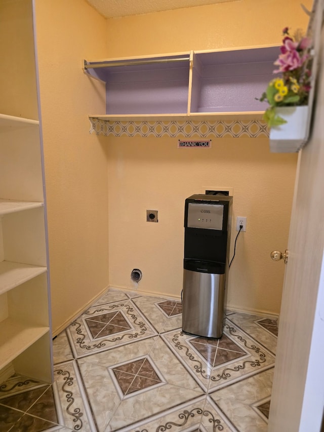 laundry room with tile patterned floors, electric dryer hookup, and laundry area