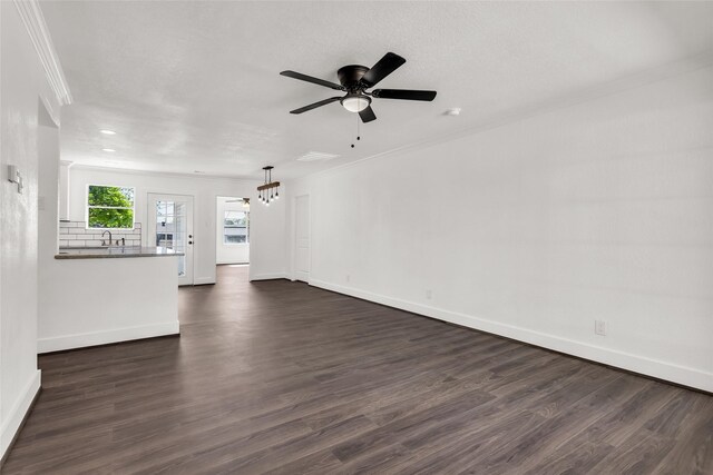 4343 Birch Dr, Mesquite, TX 75150 - unfurnished living room with ornamental molding, dark wood-type flooring, and a ceiling fan
