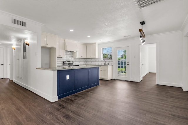 4343 Birch Dr, Mesquite, TX 75150 - kitchen with stainless steel electric range, light countertops, white cabinets, dark wood finished floors, and ornamental molding