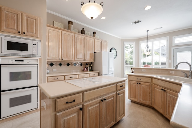kitchen with light brown cabinetry, a sink, visible vents, white appliances, and crown molding