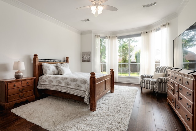 bedroom featuring a ceiling fan, visible vents, dark wood-type flooring, and ornamental molding