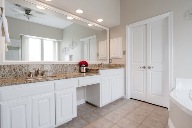 full bath with ceiling fan, a sink, double vanity, and recessed lighting