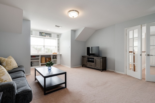 carpeted living area featuring baseboards and visible vents