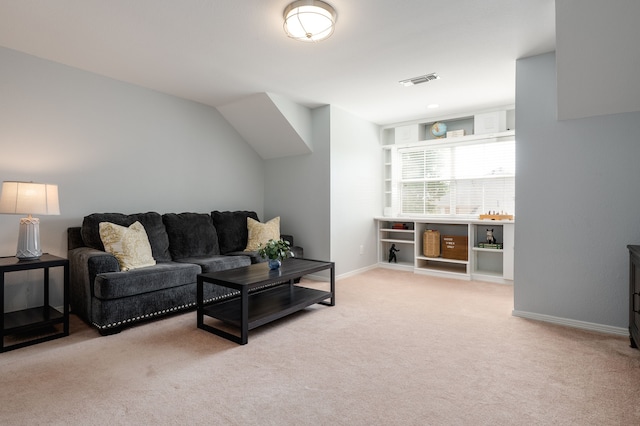 living room featuring baseboards, visible vents, and light colored carpet