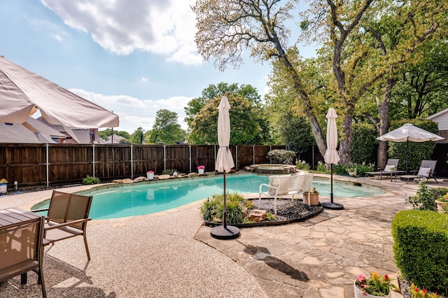 view of pool featuring a patio, a fenced backyard, a fenced in pool, and an in ground hot tub