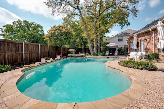view of swimming pool with a patio area, a fenced backyard, and a fenced in pool
