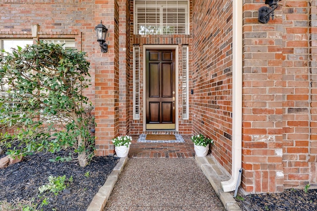 doorway to property with brick siding