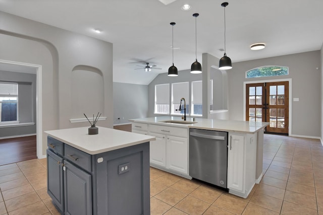 9409 Stonewood Dr, Mckinney, TX 75072 - kitchen with a kitchen island with sink, stainless steel dishwasher, a sink, light tile patterned flooring, and lofted ceiling