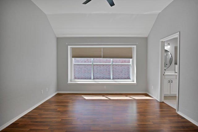 9409 Stonewood Dr, Mckinney, TX 75072 - spare room featuring lofted ceiling, a ceiling fan, dark wood-type flooring, and baseboards