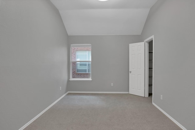 9409 Stonewood Dr, Mckinney, TX 75072 - empty room featuring vaulted ceiling, carpet flooring, and baseboards