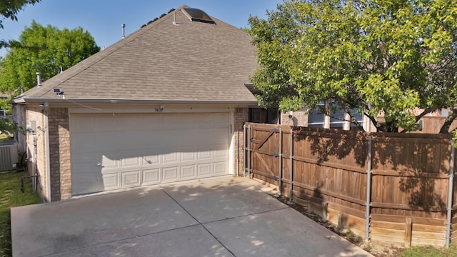 9409 Stonewood Dr, Mckinney, TX 75072 - view of property exterior with brick siding, roof with shingles, fence, and a detached garage