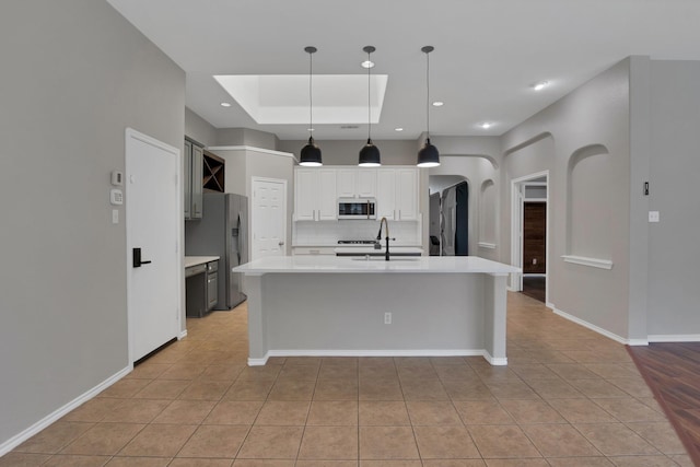 9409 Stonewood Dr, Mckinney, TX 75072 - kitchen with white microwave, light tile patterned floors, decorative backsplash, a sink, and light countertops