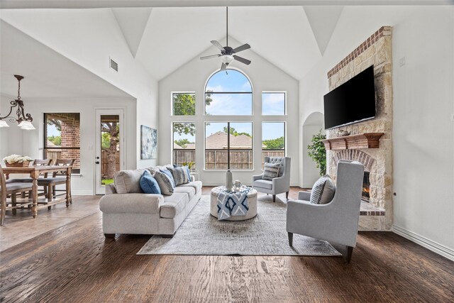 4504 Oxbow Dr, Mckinney, TX 75072 - living room featuring a fireplace, ceiling fan, baseboards, wood finished floors, and a high ceiling
