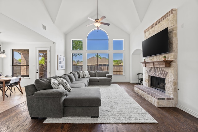 4504 Oxbow Dr, Mckinney, TX 75072 - living area featuring a ceiling fan, a stone fireplace, high vaulted ceiling, and wood finished floors