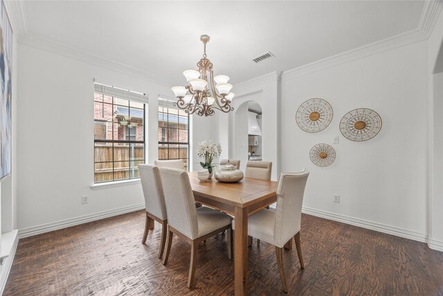 4504 Oxbow Dr, Mckinney, TX 75072 - dining space with a chandelier, ornamental molding, wood finished floors, arched walkways, and baseboards