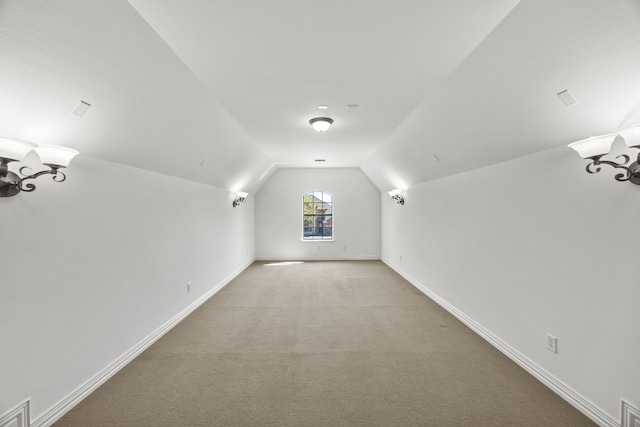 4504 Oxbow Dr, Mckinney, TX 75072 - bonus room featuring lofted ceiling, light carpet, and baseboards
