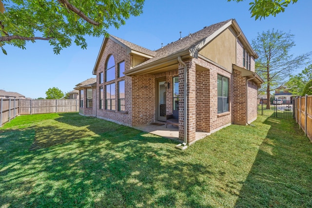 4504 Oxbow Dr, Mckinney, TX 75072 - back of house featuring brick siding, a patio, and a shingled roof