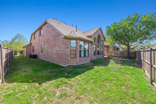 4504 Oxbow Dr, Mckinney, TX 75072 - back of house featuring brick siding, central AC unit, and a shingled roof