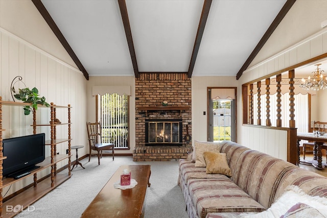 6307 Bocage Dr, Shreveport, LA 71119 - living area featuring an inviting chandelier, wood walls, a brick fireplace, carpet, and vaulted ceiling with beams