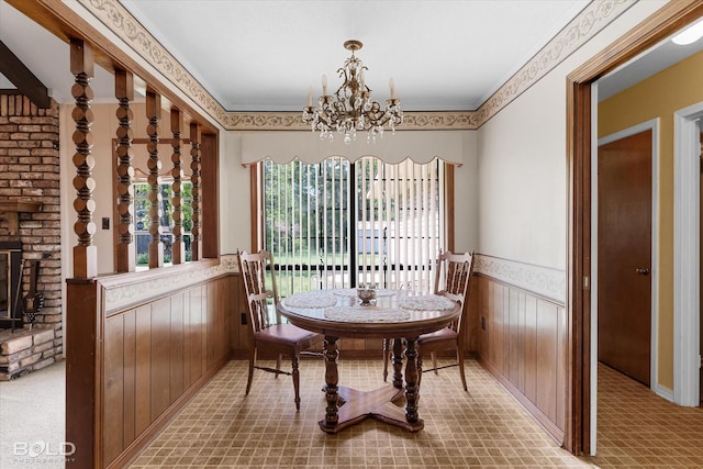 6307 Bocage Dr, Shreveport, LA 71119 - dining area with ornamental molding, wood walls, an inviting chandelier, and wainscoting
