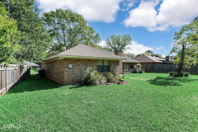 6307 Bocage Dr, Shreveport, LA 71119 - back of house with a yard, a fenced backyard, brick siding, and a chimney