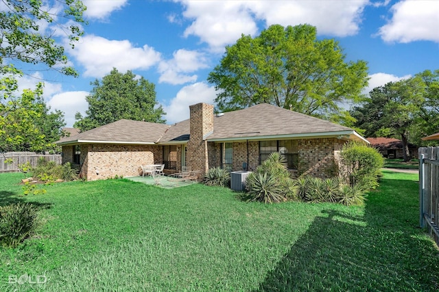 6307 Bocage Dr, Shreveport, LA 71119 - back of property with cooling unit, brick siding, fence, and a lawn