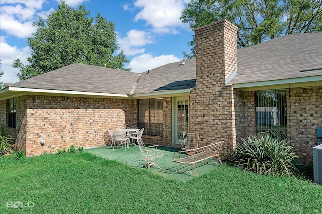 6307 Bocage Dr, Shreveport, LA 71119 - rear view of property with a lawn, a patio area, brick siding, a chimney, and a shingled roof
