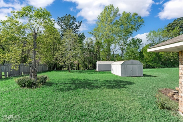 6307 Bocage Dr, Shreveport, LA 71119 - view of yard featuring a storage shed, an outbuilding, and fence