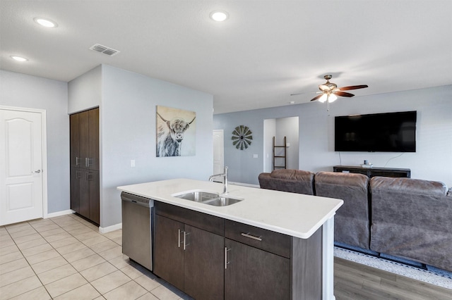 kitchen featuring visible vents, a sink, light countertops, a kitchen island with sink, and stainless steel dishwasher