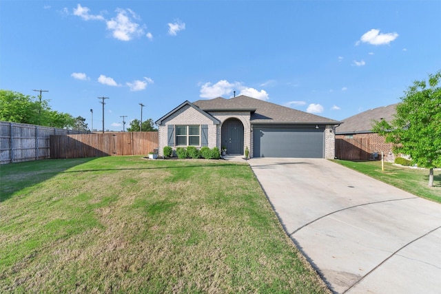 ranch-style home featuring fence, a front lawn, brick siding, a garage, and driveway