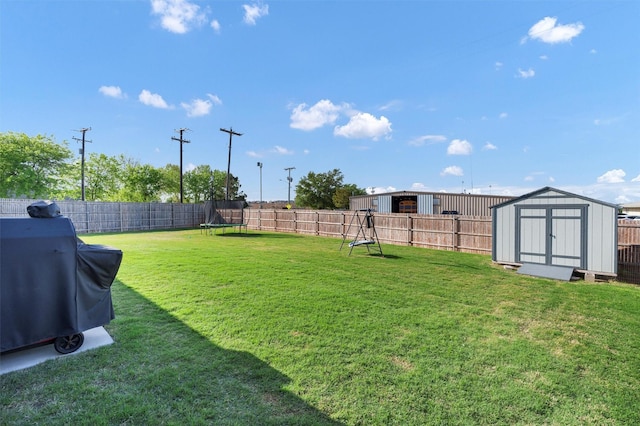view of yard featuring a trampoline, an outdoor structure, a fenced backyard, and a storage shed