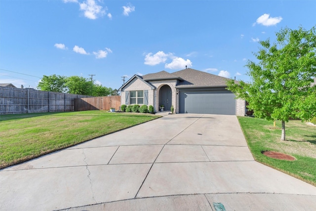 single story home with a garage, fence, brick siding, a front lawn, and driveway