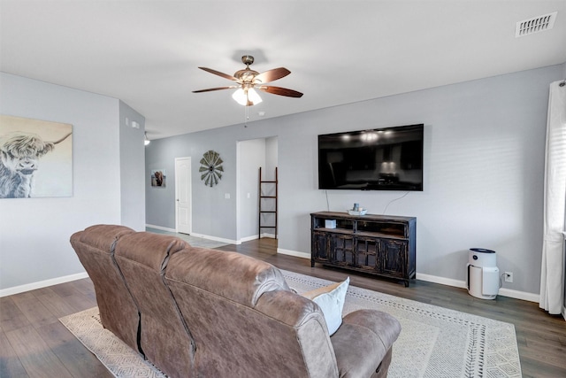 living area with wood finished floors, ceiling fan, baseboards, and visible vents