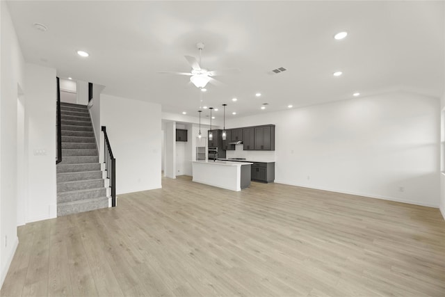 1905 Bobbin Ml, Forney, TX 75126 - unfurnished living room with ceiling fan, recessed lighting, stairway, light wood-type flooring, and baseboards