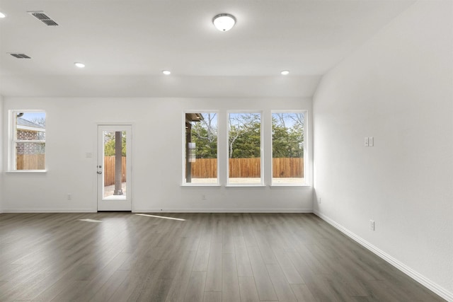 unfurnished living room with dark wood-style flooring, baseboards, and recessed lighting