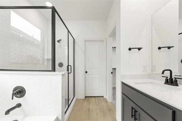 1905 Bobbin Ml, Forney, TX 75126 - bathroom featuring a stall shower, wood finished floors, vanity, and a tub to relax in