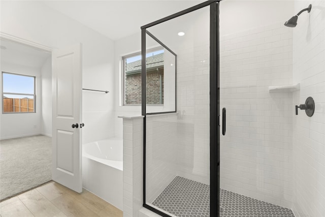 1905 Bobbin Ml, Forney, TX 75126 - full bath featuring plenty of natural light, a bath, a stall shower, and wood finished floors